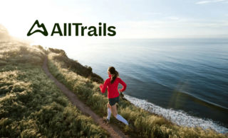 Women running down a dirt trail along water