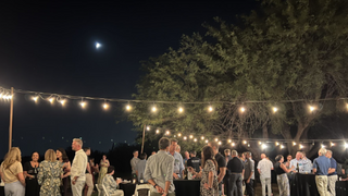 Finance, People, and Legal leaders gathered for evening drinks under fairy lights